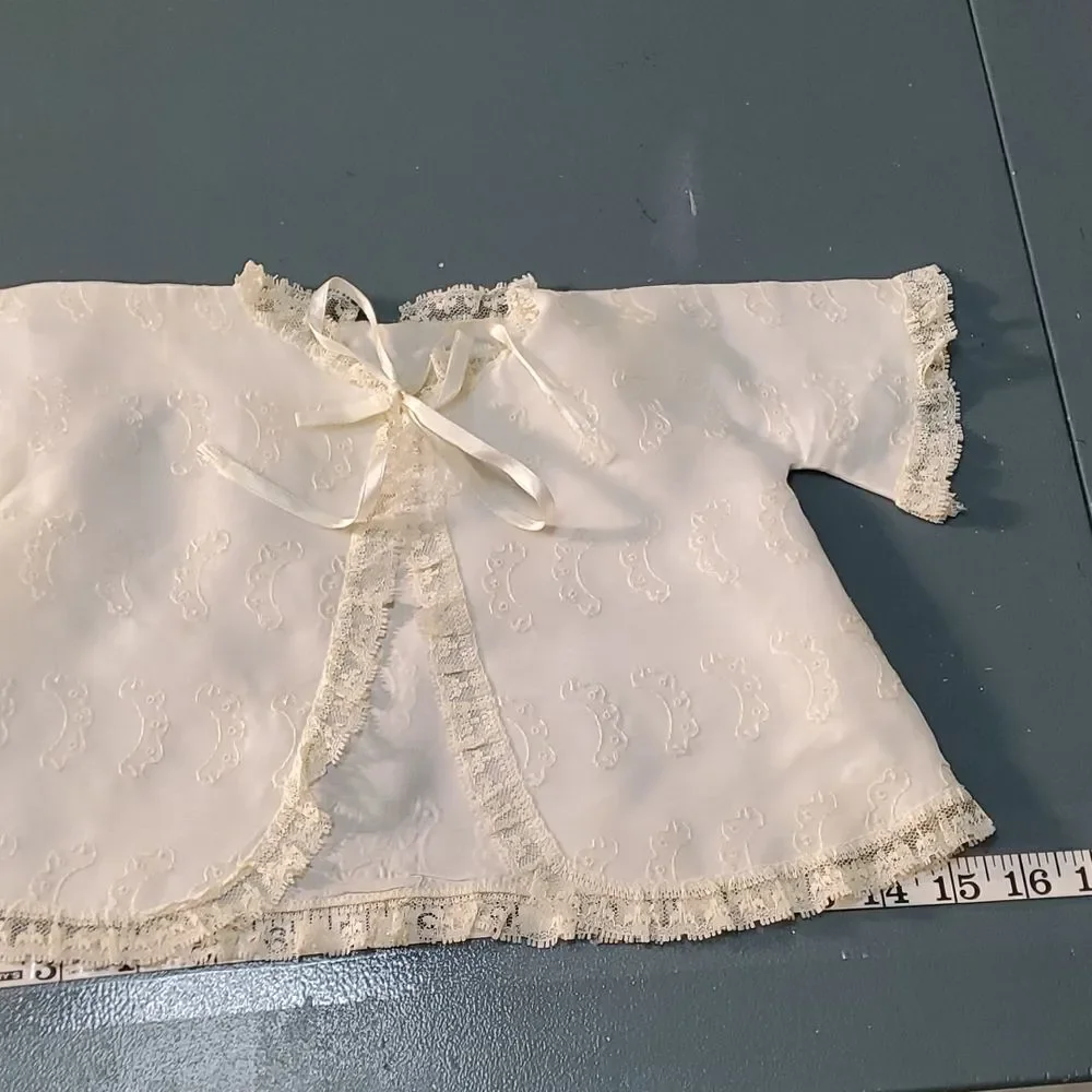 Vintage baby dress with jacket. Trimmed in lace with tie. The jacket has enbroid